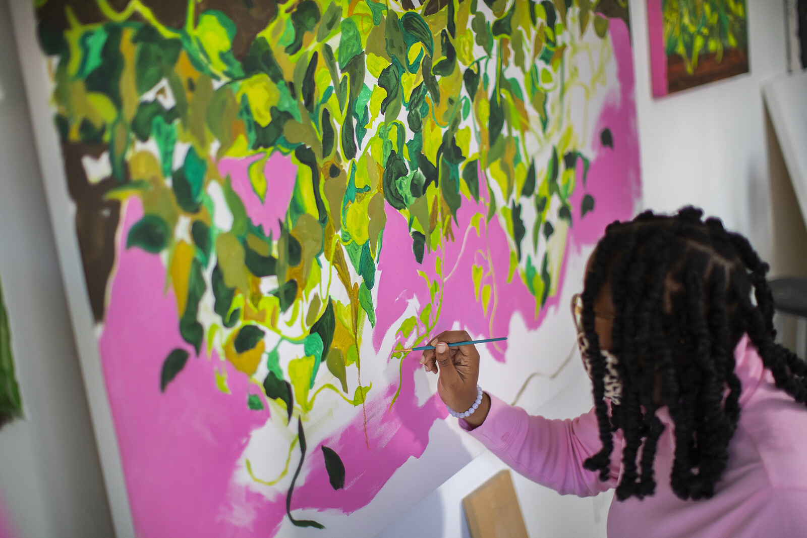 graduate student painting a mural